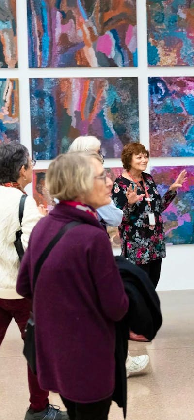 our group in front of Emily Kam Kngwarray's colourful paintings