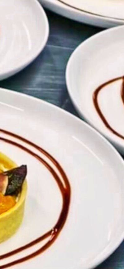 Plated entree of vegetable tarts