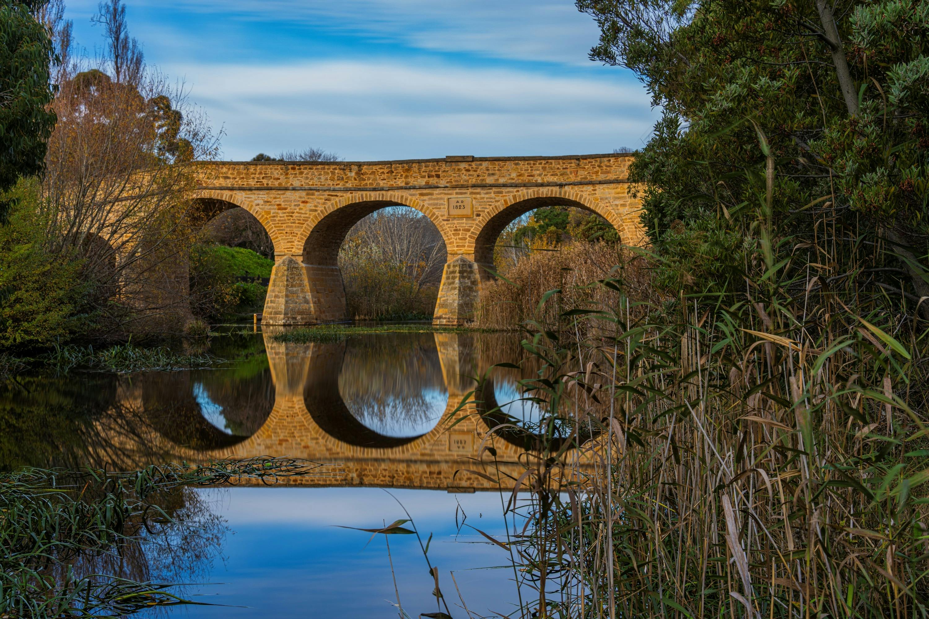 Tasmania's Historical Richmond Bridge reflecting in the Coal River.