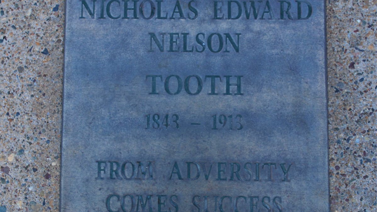 photo of lpaque for Nicholas Tooth which reads From Adversity Comes Success