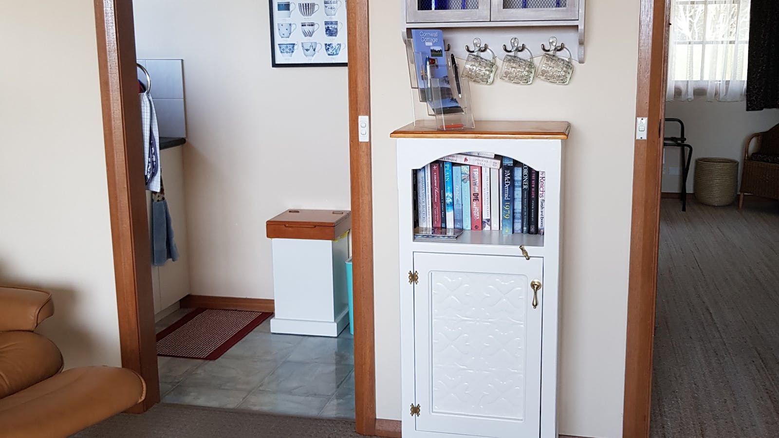 Kitchenette equipped with bench oven, microwave, hotplates, sink, pots, pans, crockery & cutlery.