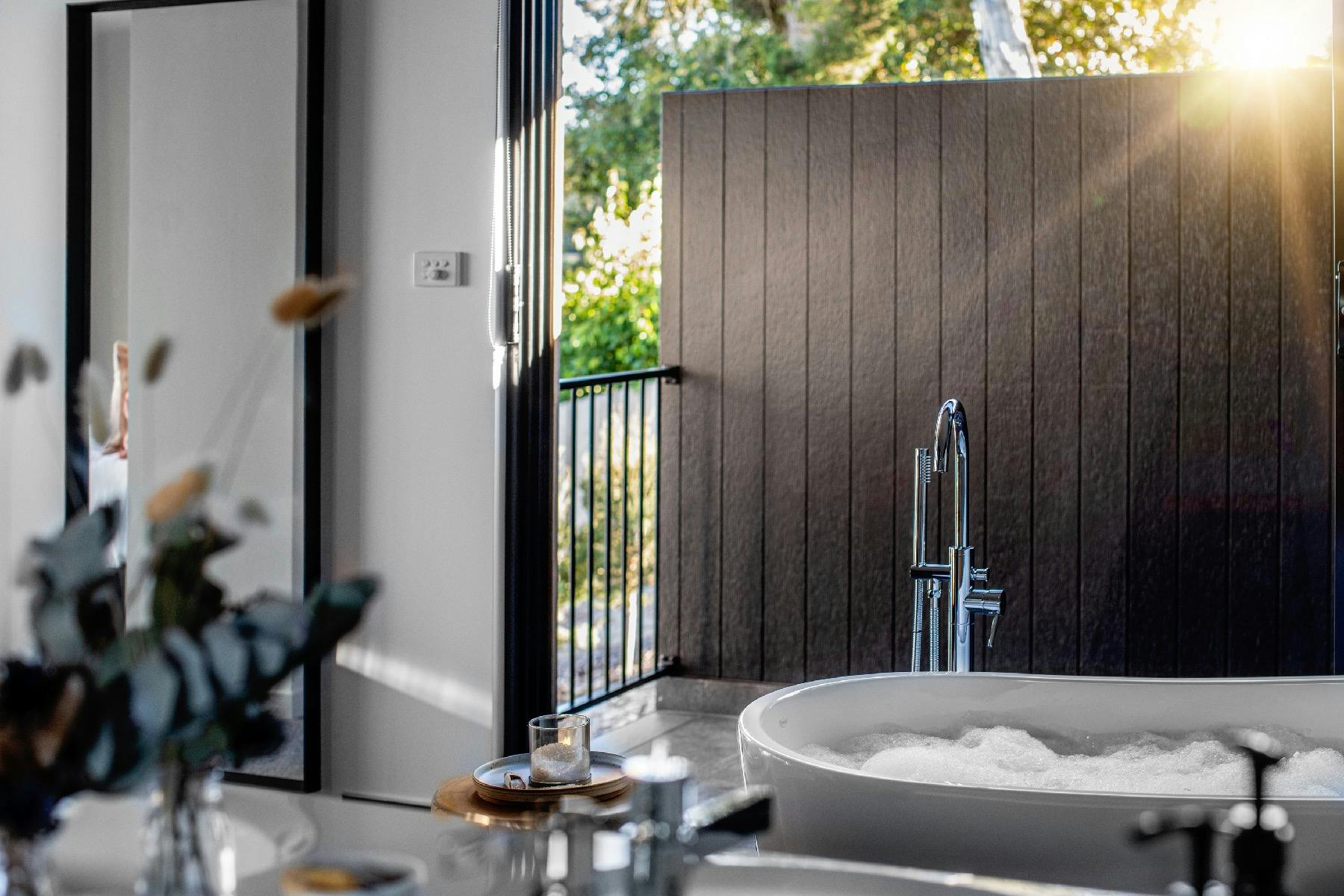 The spa bath in the main bedroom ensuite. Sit in the bath and enjoy the views of the river.