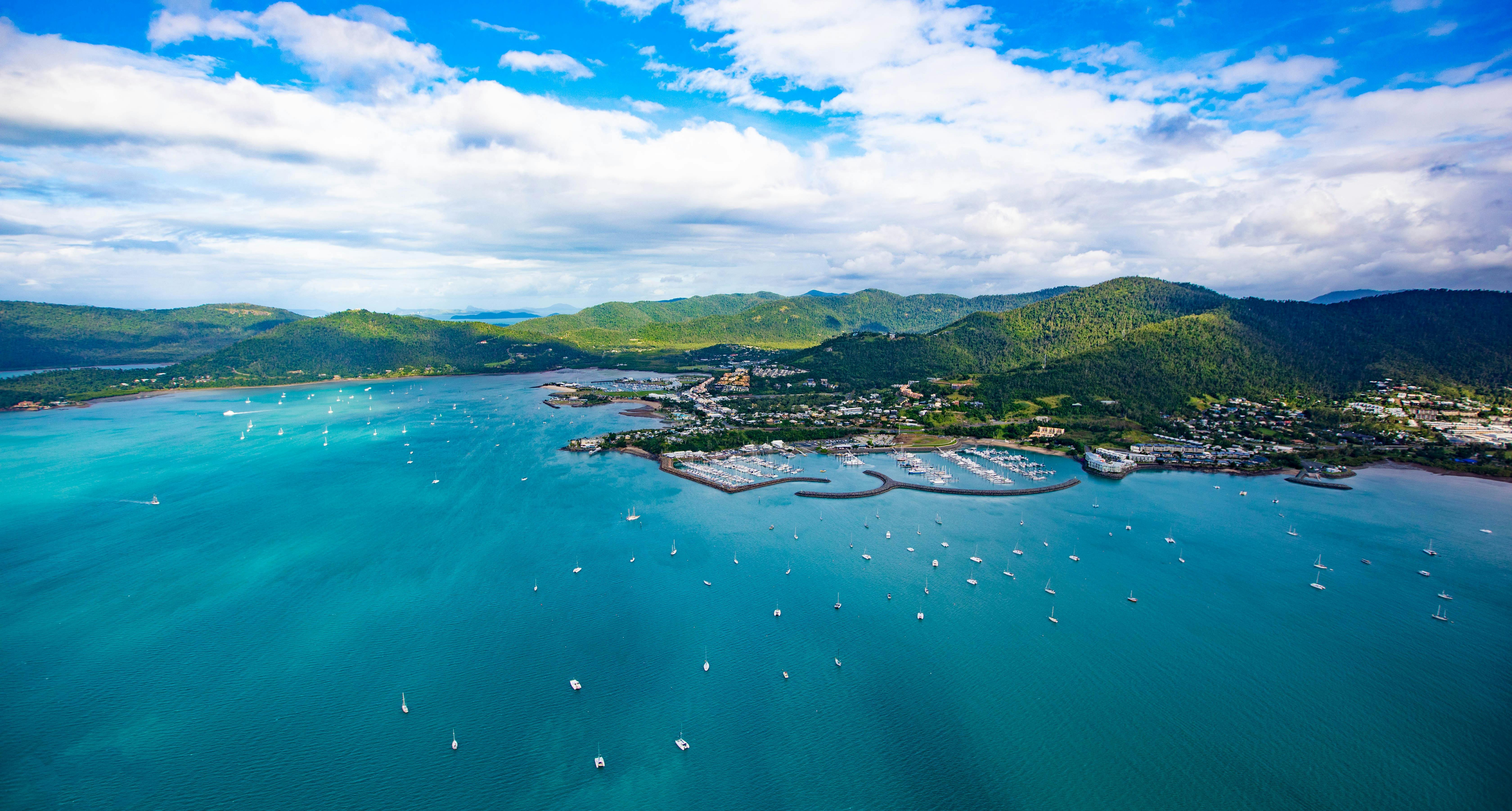 Aerial view of Airlie Beach coastline and surrounding greenery of Conway National Park