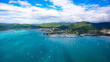 Aerial view of Airlie Beach coastline and surrounding greenery of Conway National Park
