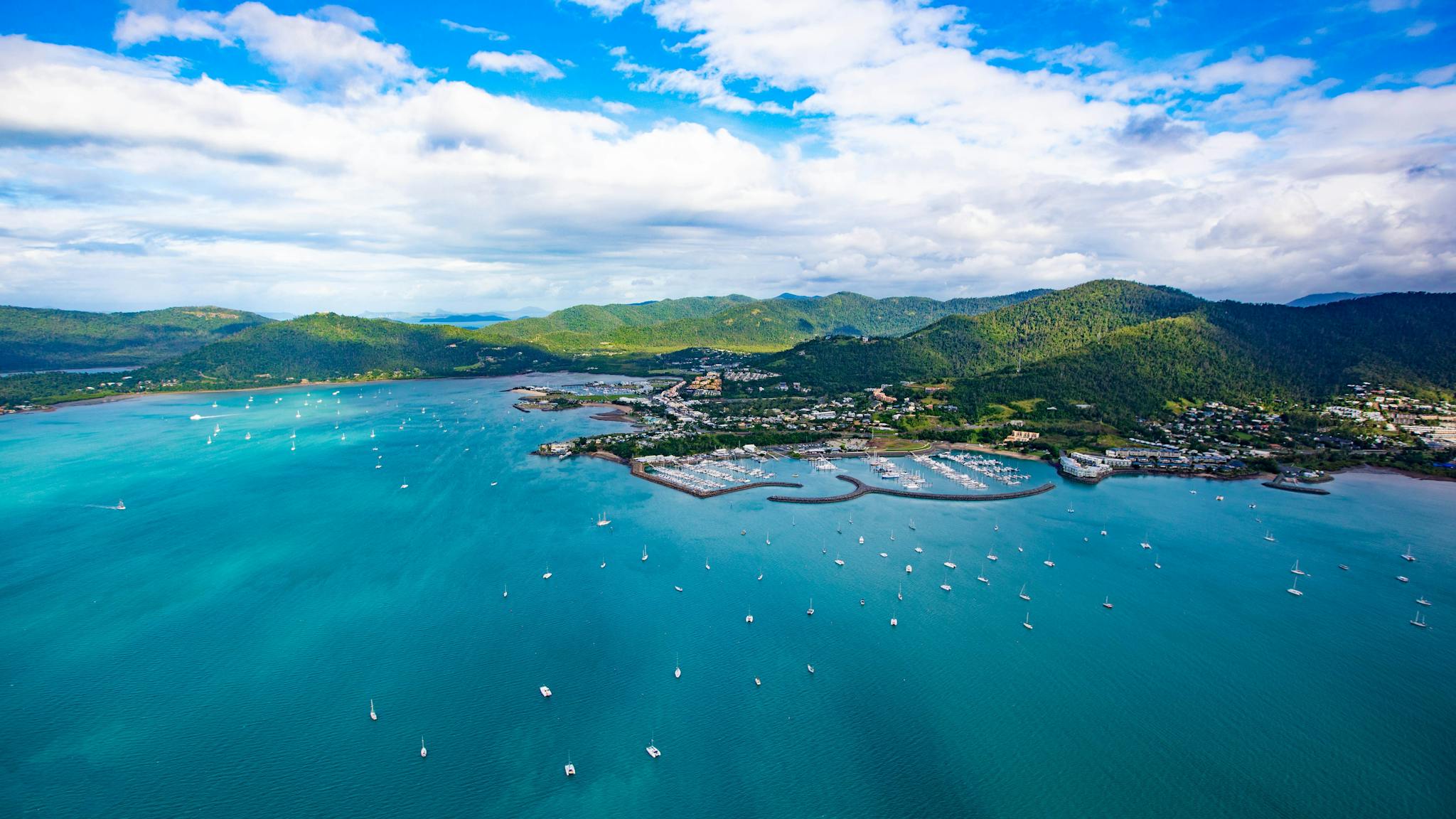 Aerial view of Airlie Beach coastline and surrounding greenery of Conway National Park Aerial view of Airlie Beach coastline and surrounding greenery of Conway National Park
