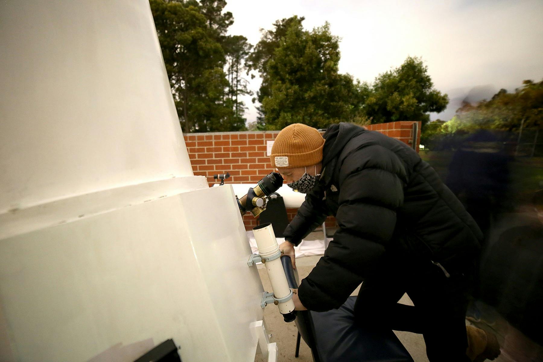 Person looking into the eyepiece on  the Federation Adcock Telescope