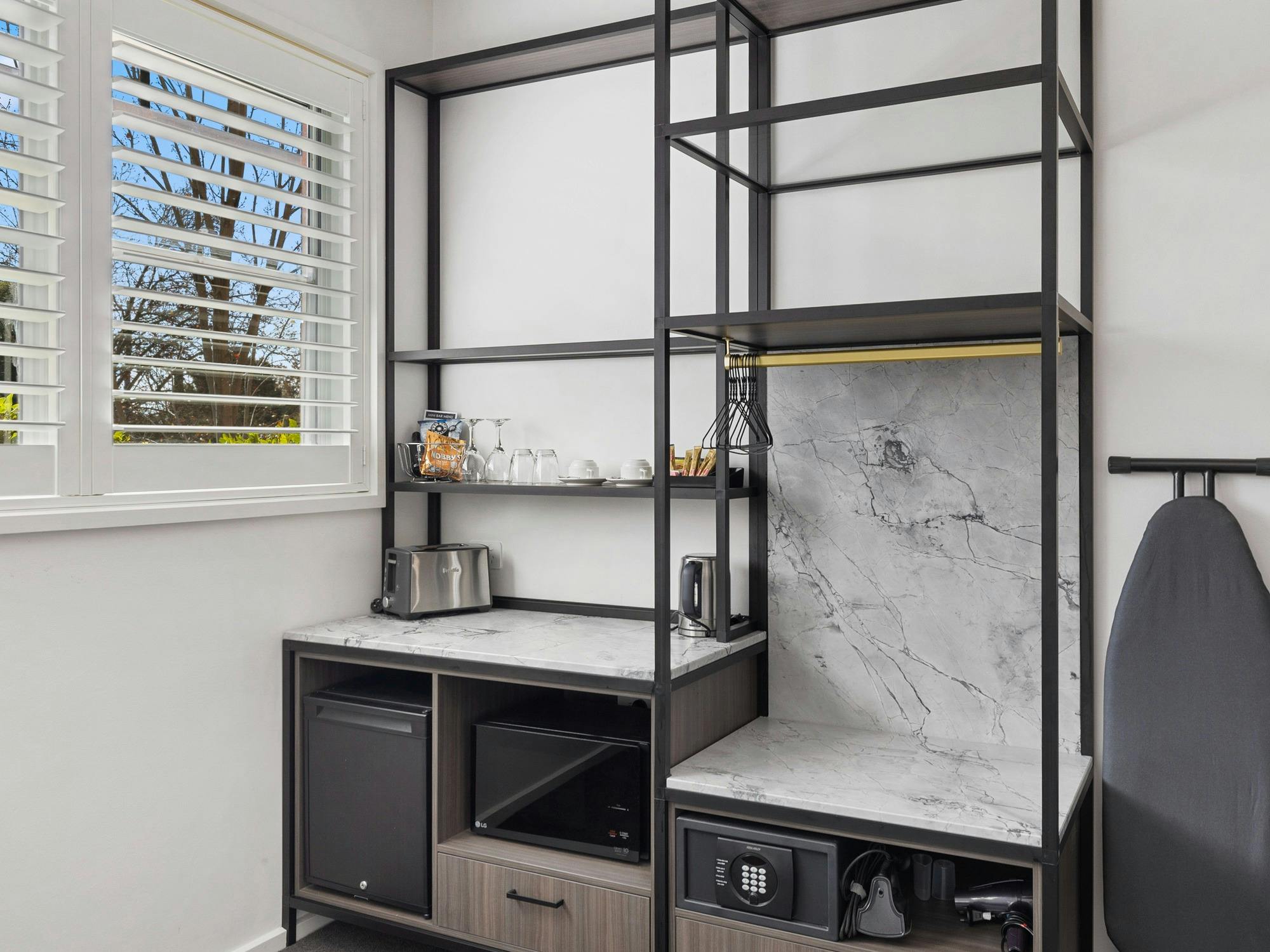 Accessible tea/coffee making, microwave, fridge and lowered open wardrobe space