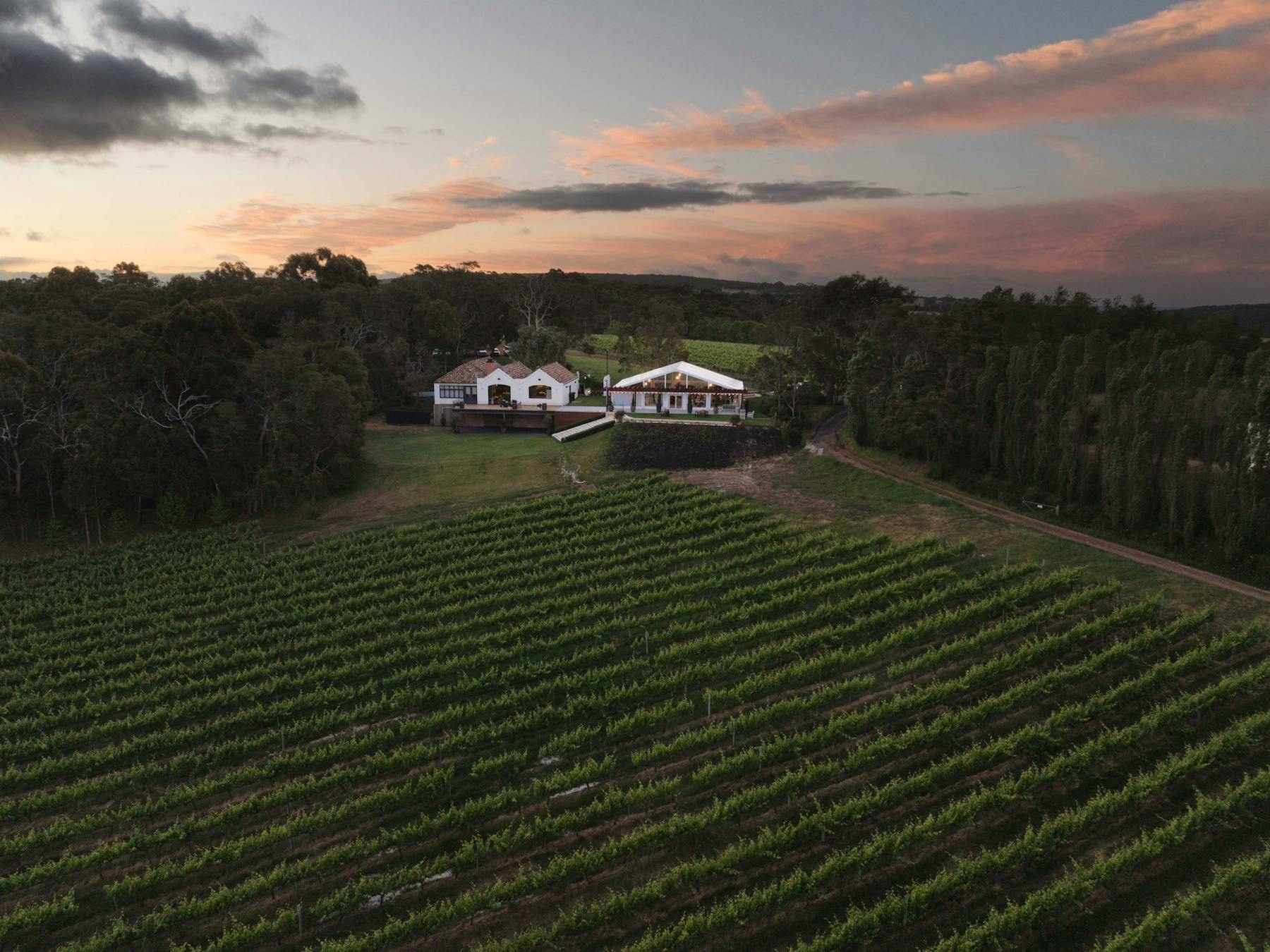 Credaro Estate Cellar Door at Yallingup, overlooking the back of venue towards a setting sun in west