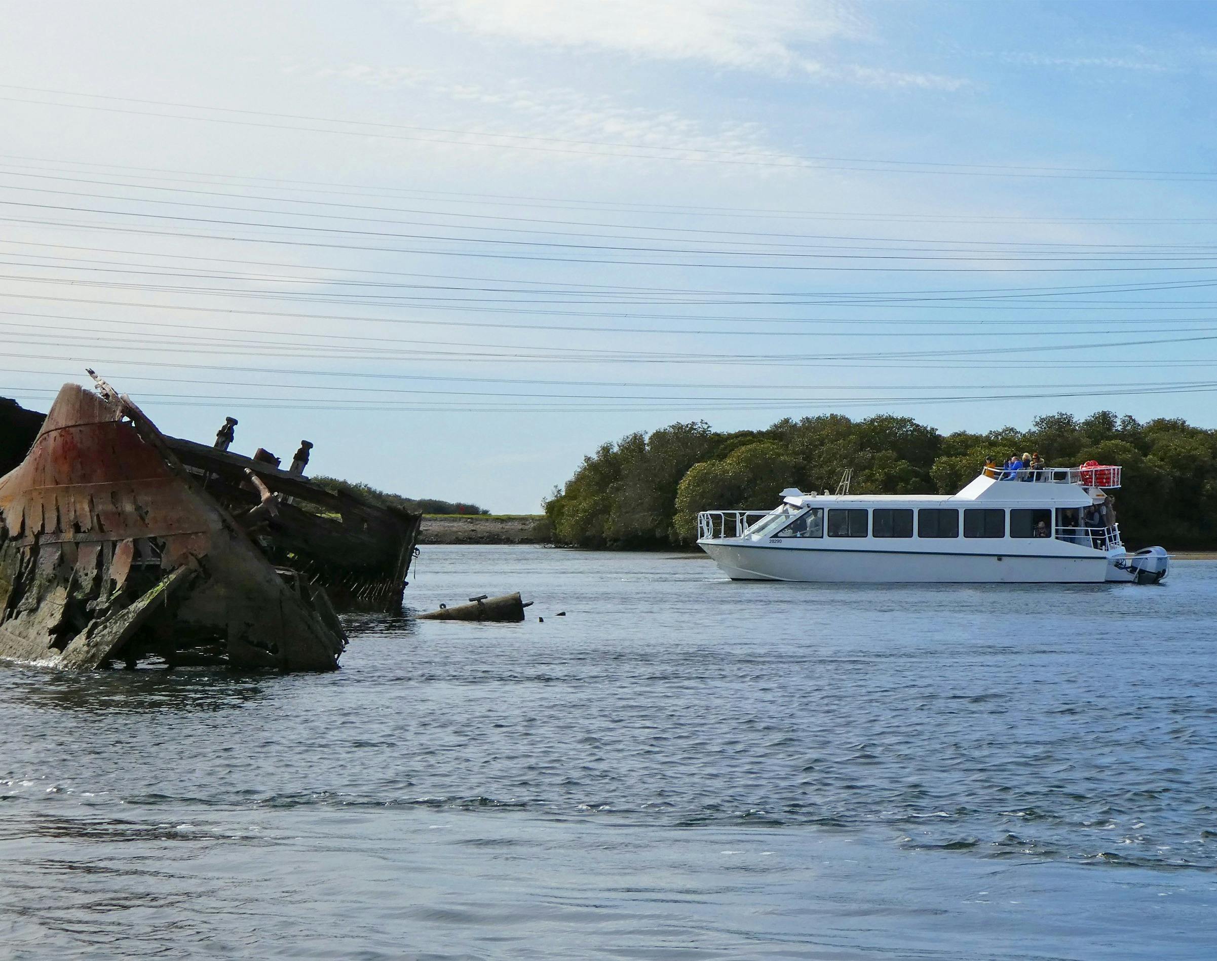 The PRC 32-Seater cruises close to the half-sunken Santiago