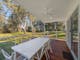 Premium cabin deck showing the outdoor dining table and views to Wangaratta