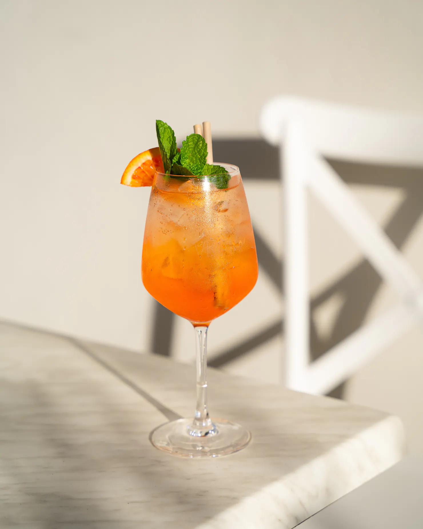 Aperol Spritz  with orange and mint garnish