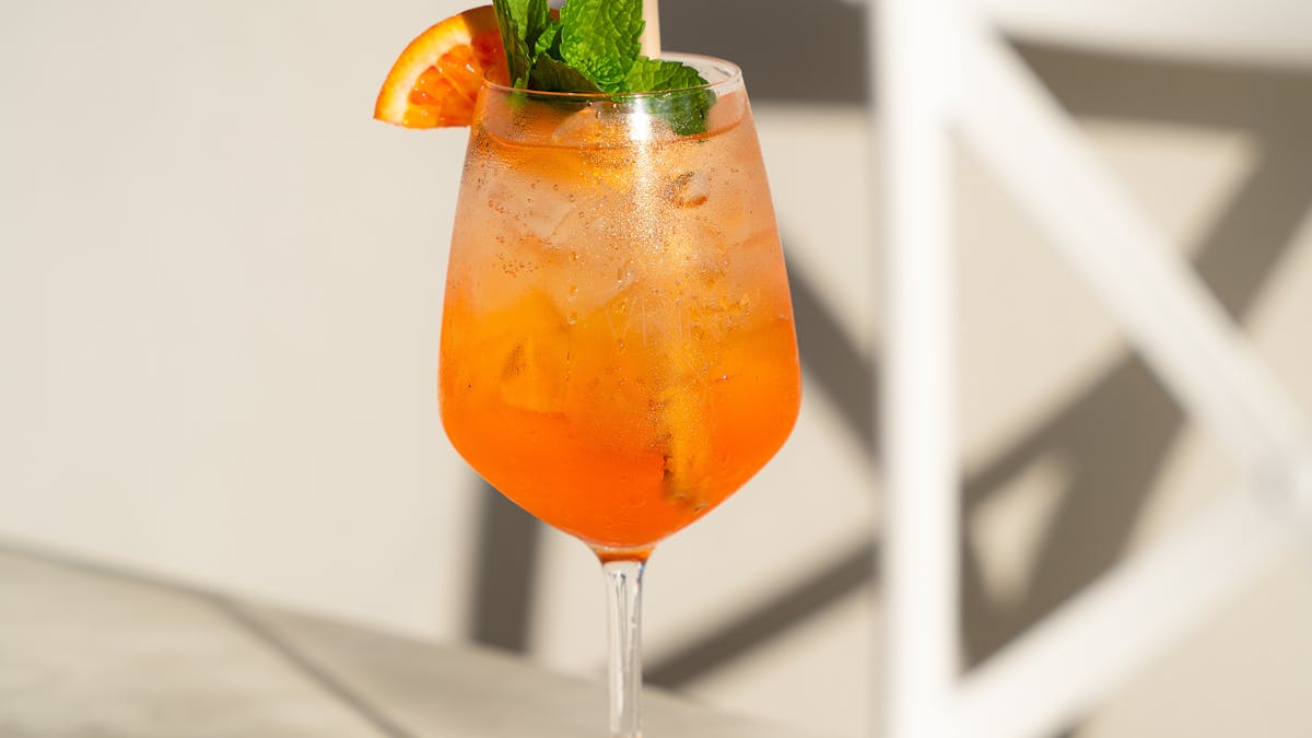 Aperol Spritz  with orange and mint garnish