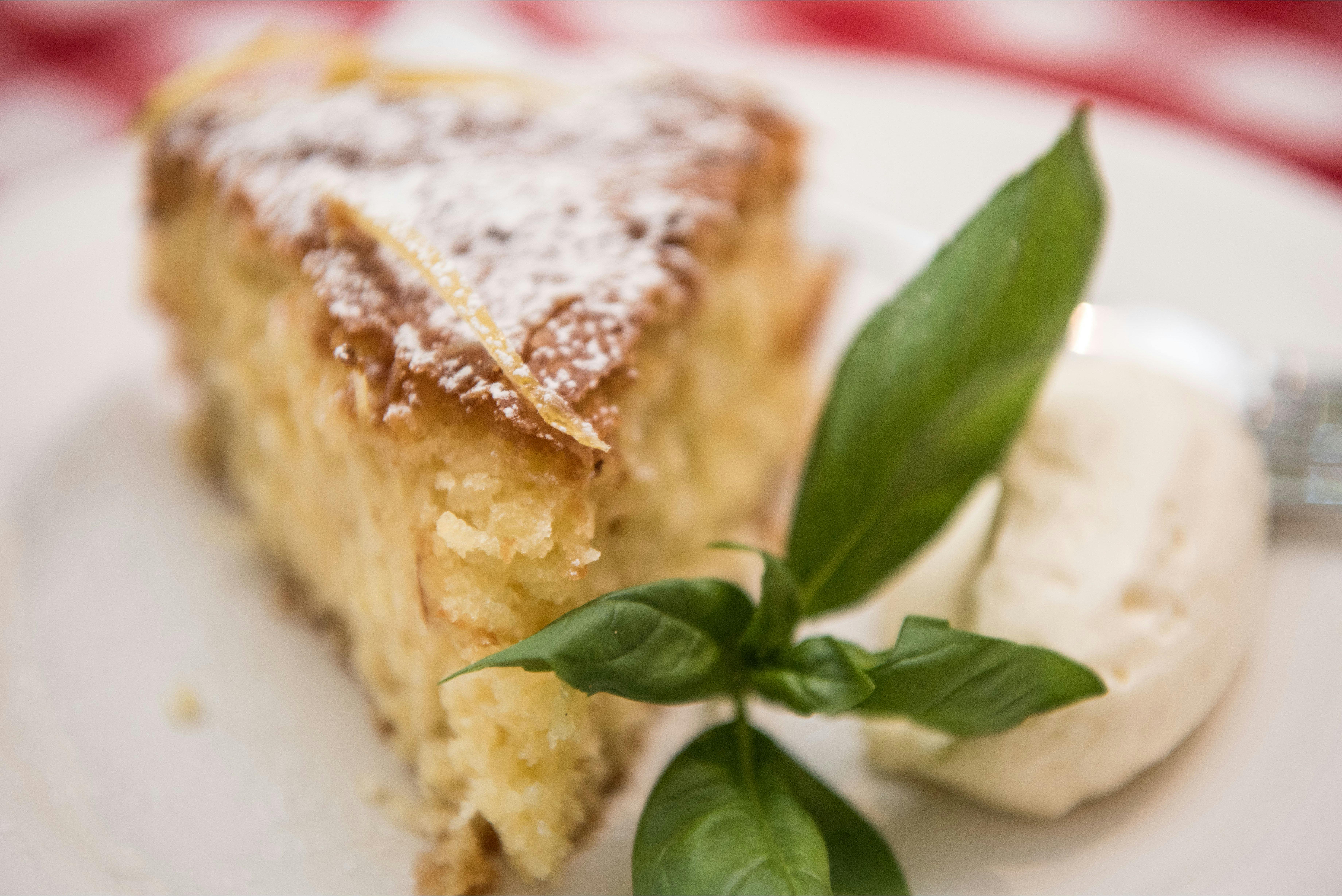 Plate with piece of cake and cream