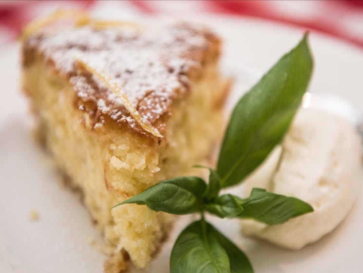 Plate with piece of cake and cream