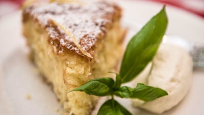Plate with piece of cake and cream