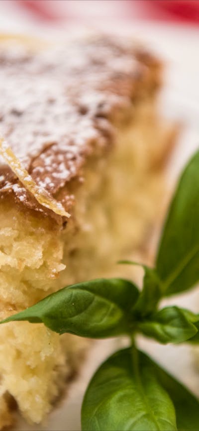 Plate with piece of cake and cream