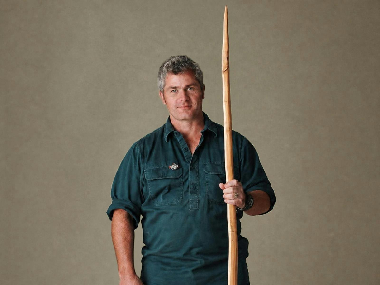 Man holding a wooden bow