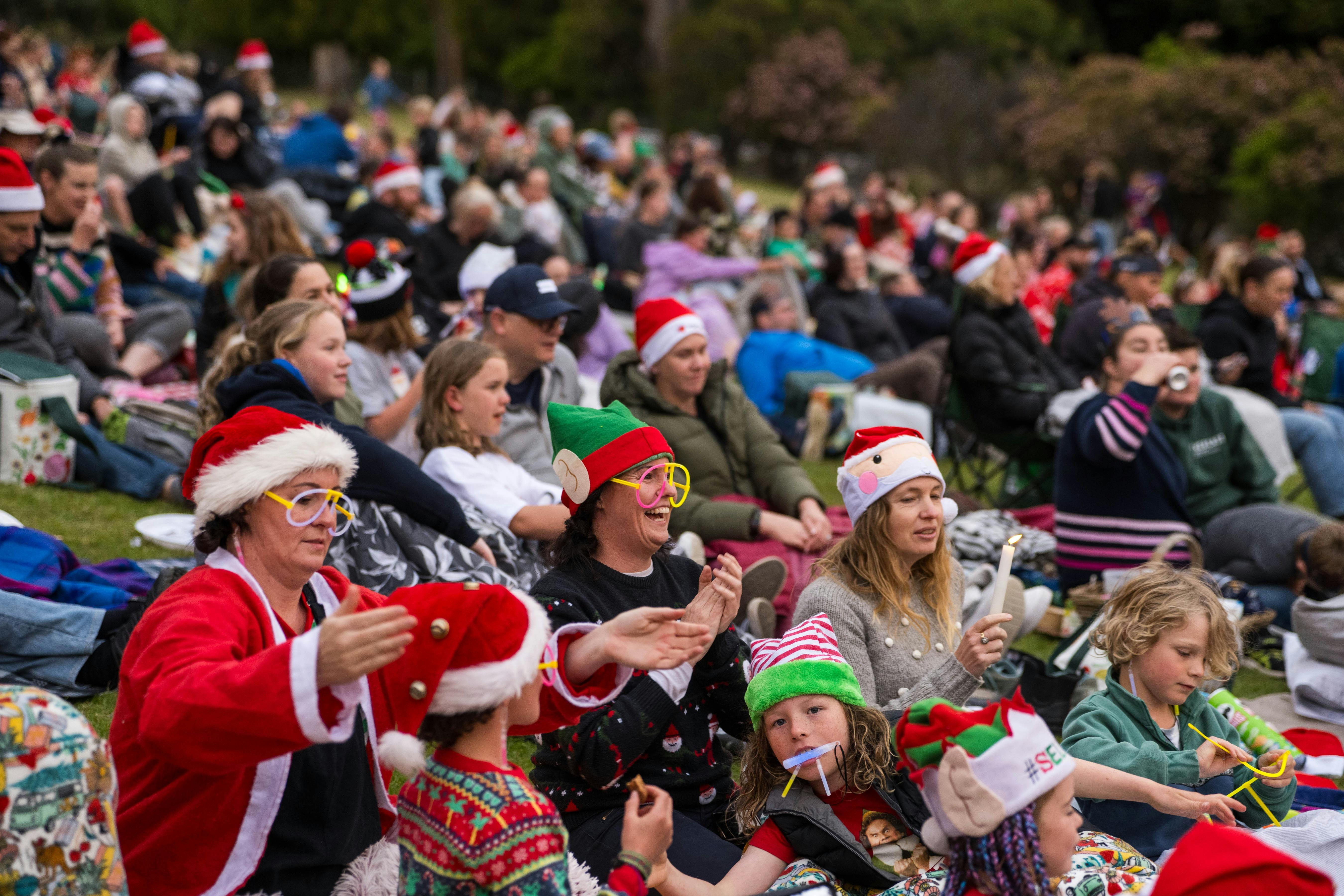 Kids and families in the audience all decked out in christmas hats and jumpers