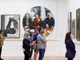 Visitors looking at paintings on the walls of Geelong Gallery