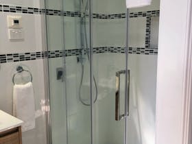 Newly renovated ensuite bathroom with floor to ceiling tiles, underfloor heating and vanity lighting