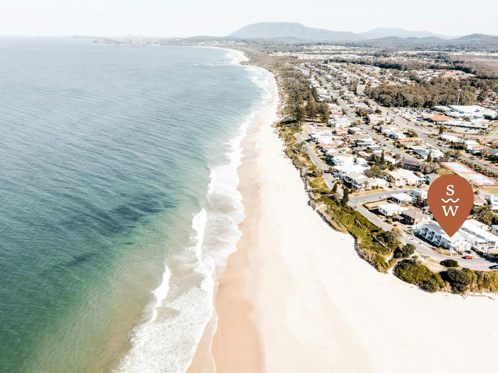 Location pin on birds eye view of Lake Cathie beachfront