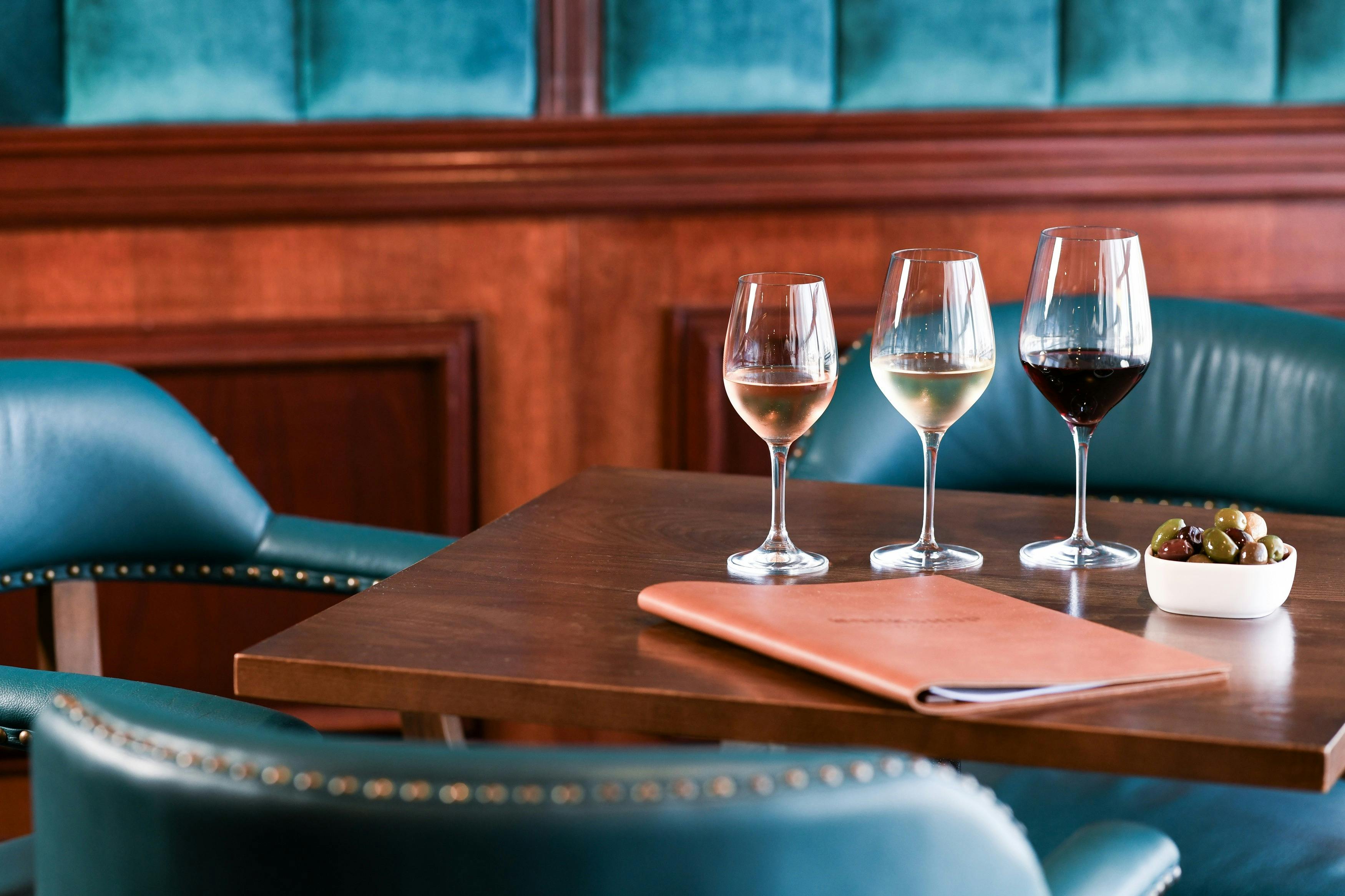 wine & olives on a table with compfortable leather chairs