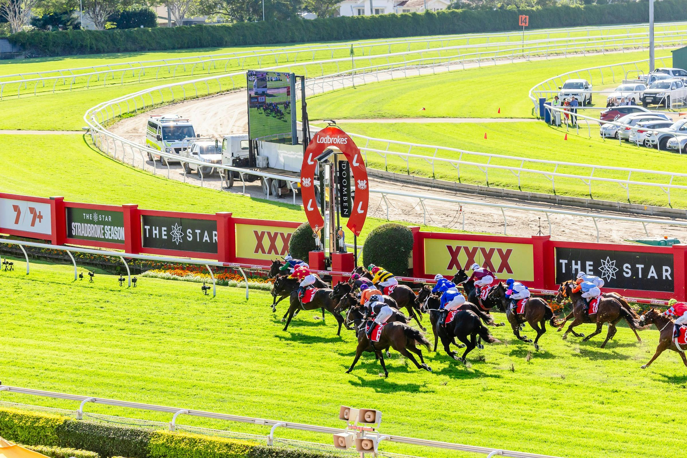 Horses run past the Doomben winning post