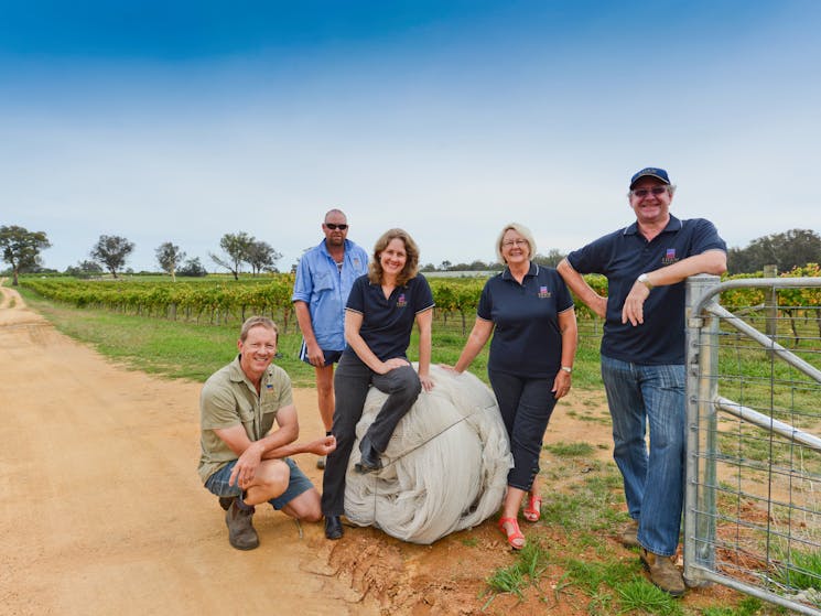 The Shaw family poses in front of their vineyard