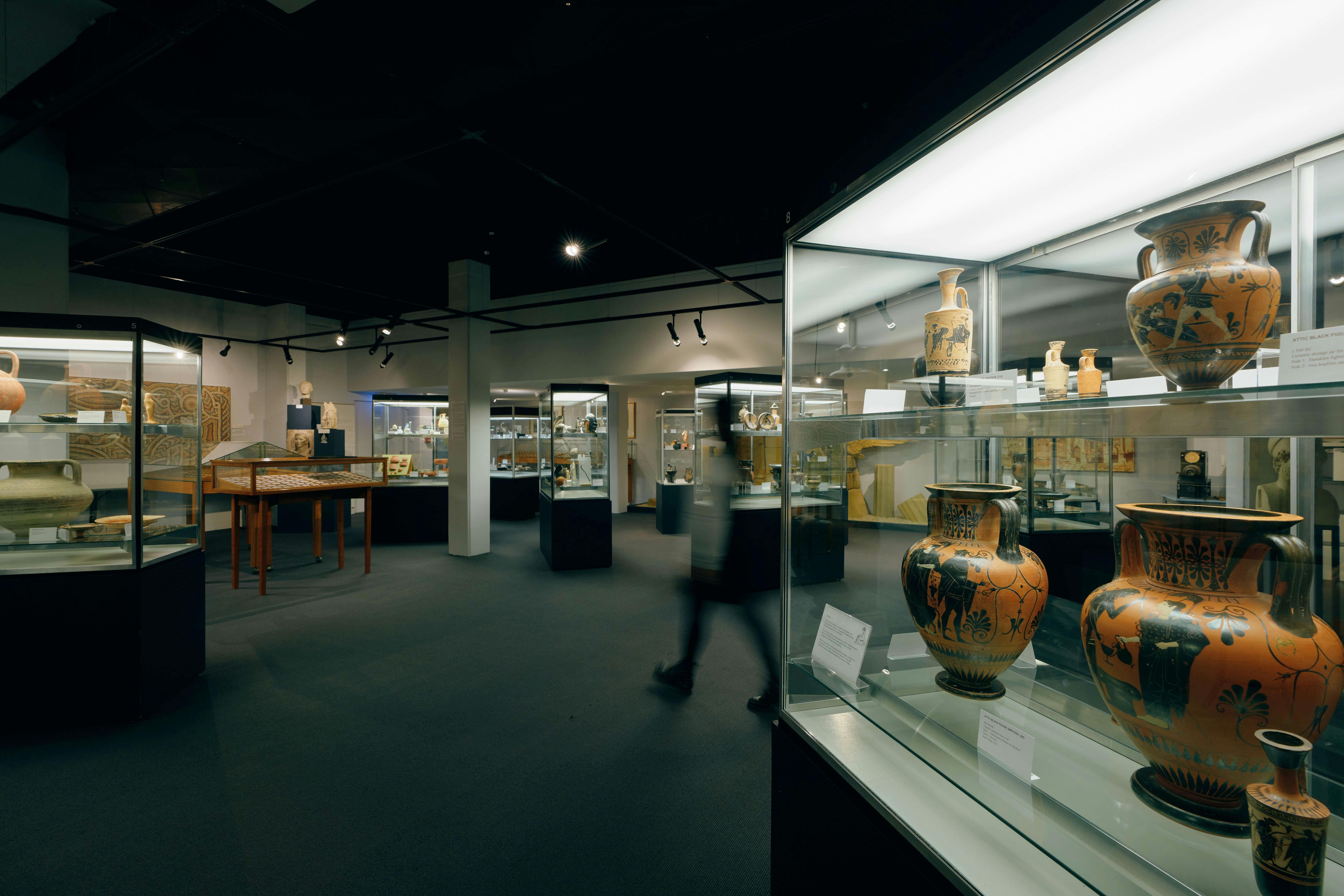 Museum interior with display cases containing Ancient Egyptian, Greek and Roman antiquities
