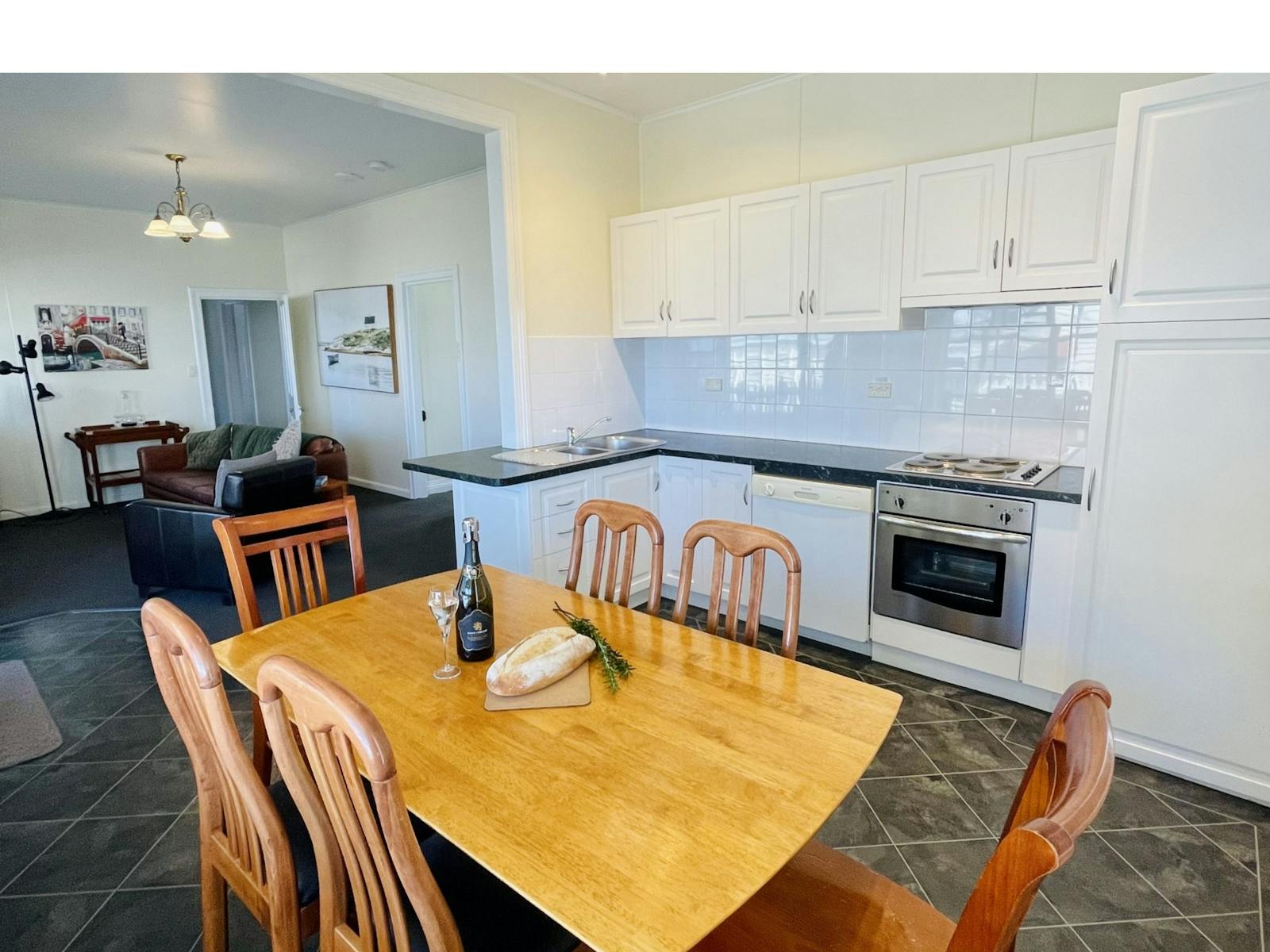 well stocked kitchen, seating for 6, open plan living area, opens onto the deck, views to the beach