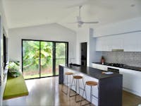 Galley kitchen with island bench and bench seat