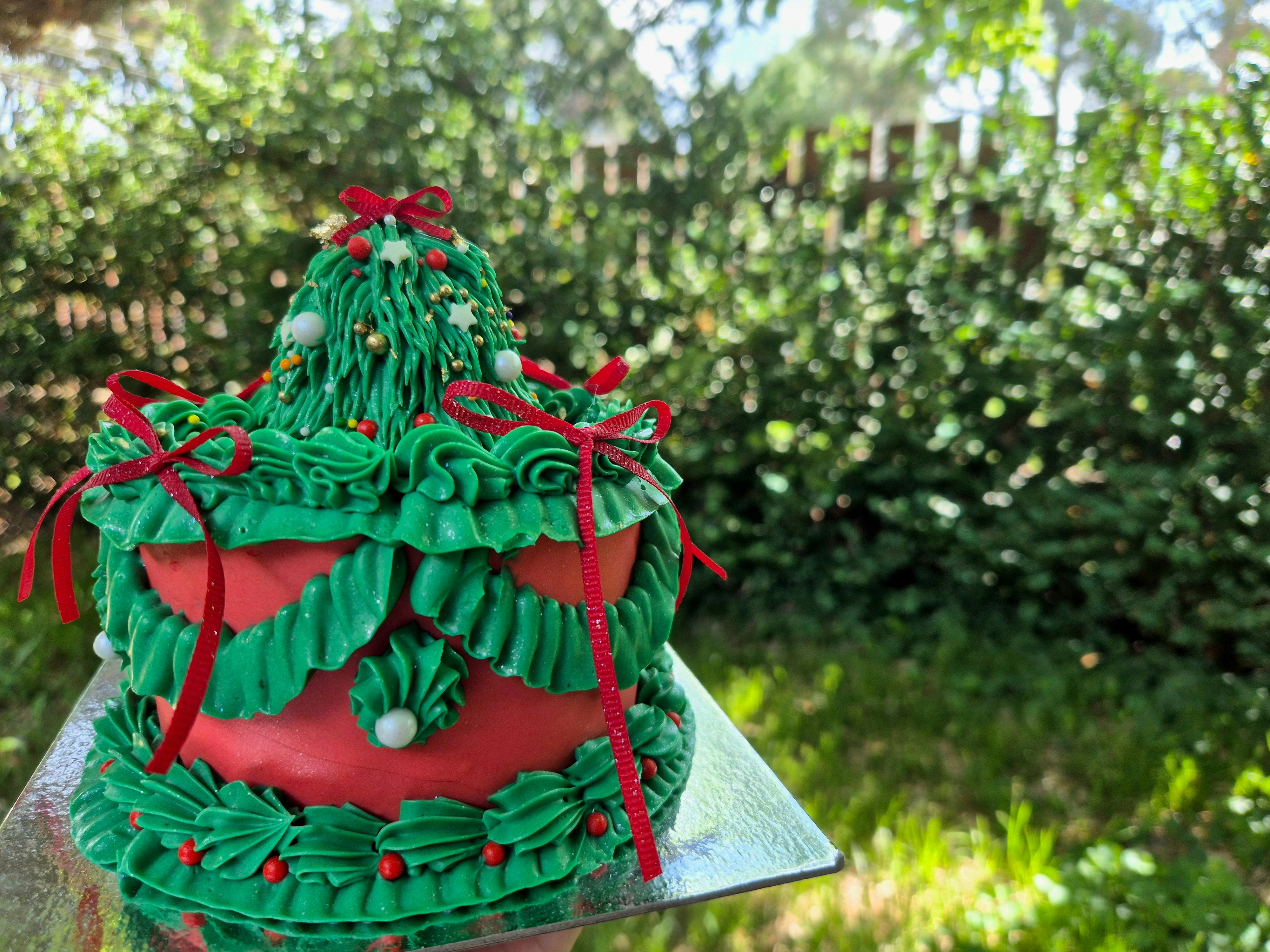 Christmas themed vintage-style green and red cake with decorations