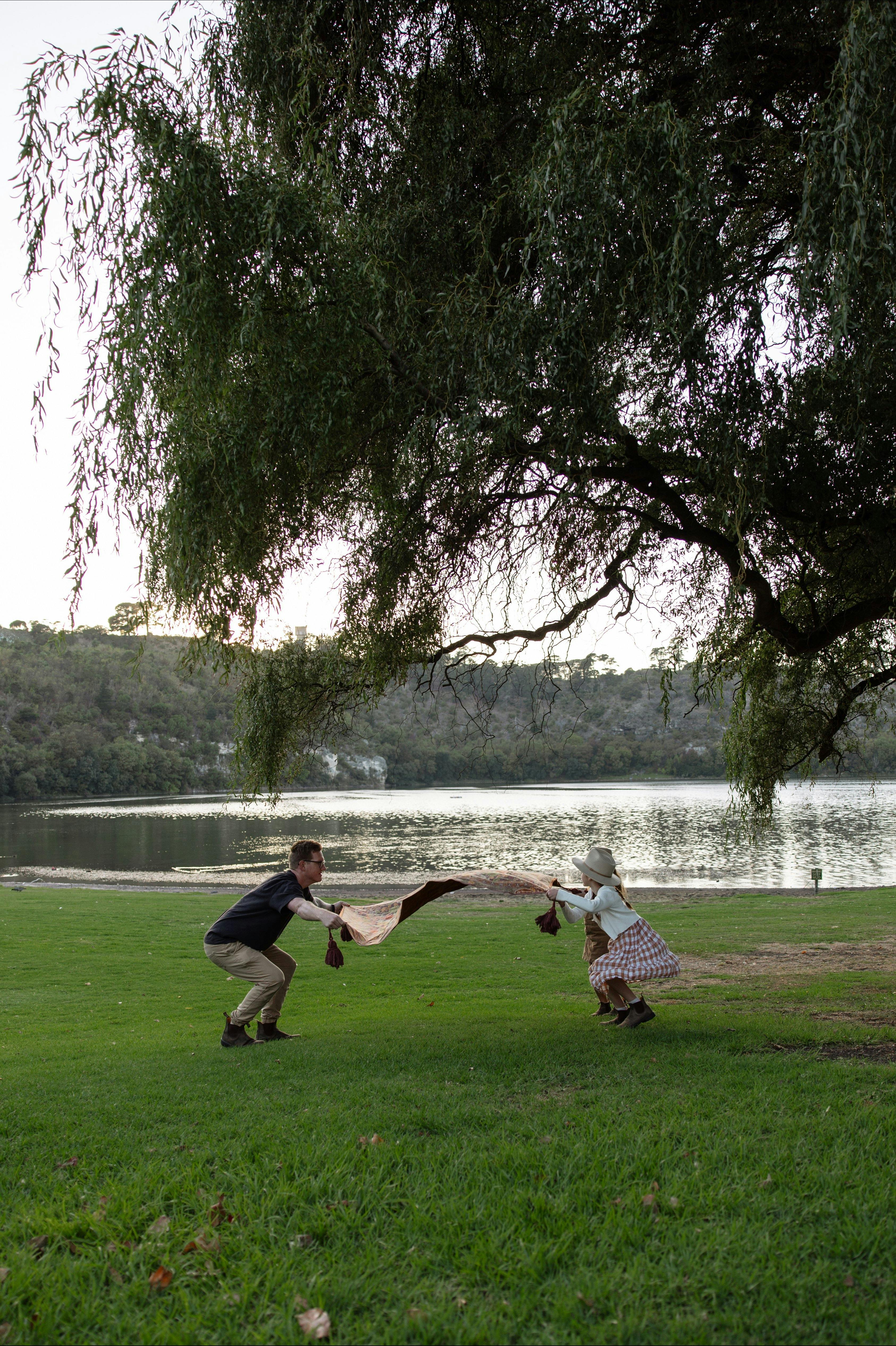 preparing a picnic rug on the grass