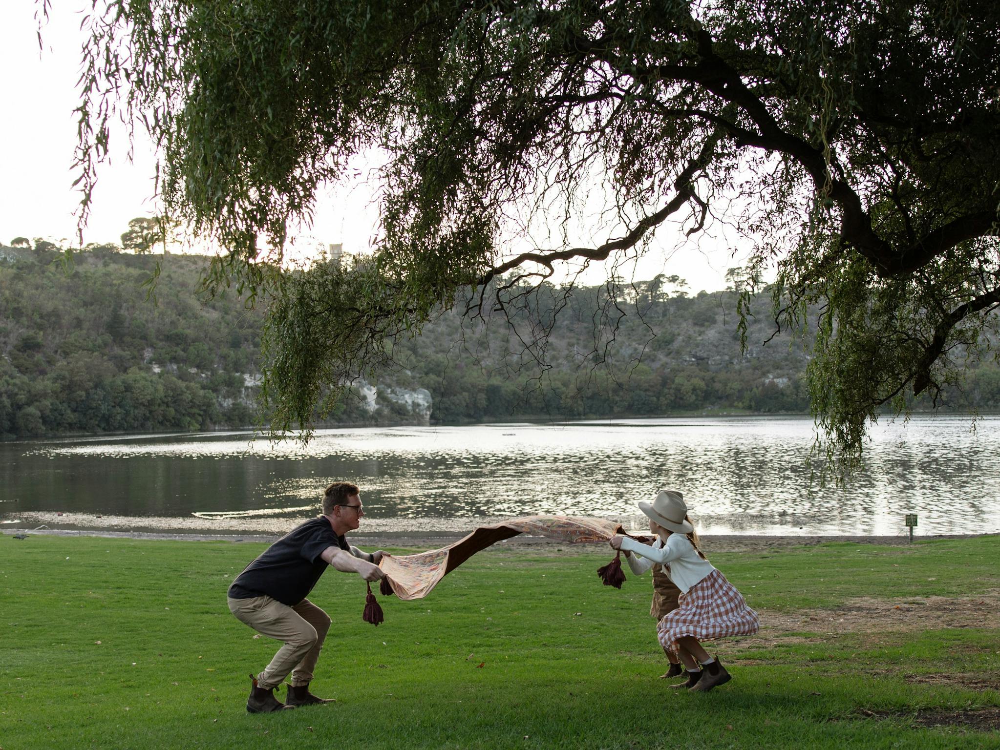 preparing a picnic rug on the grass