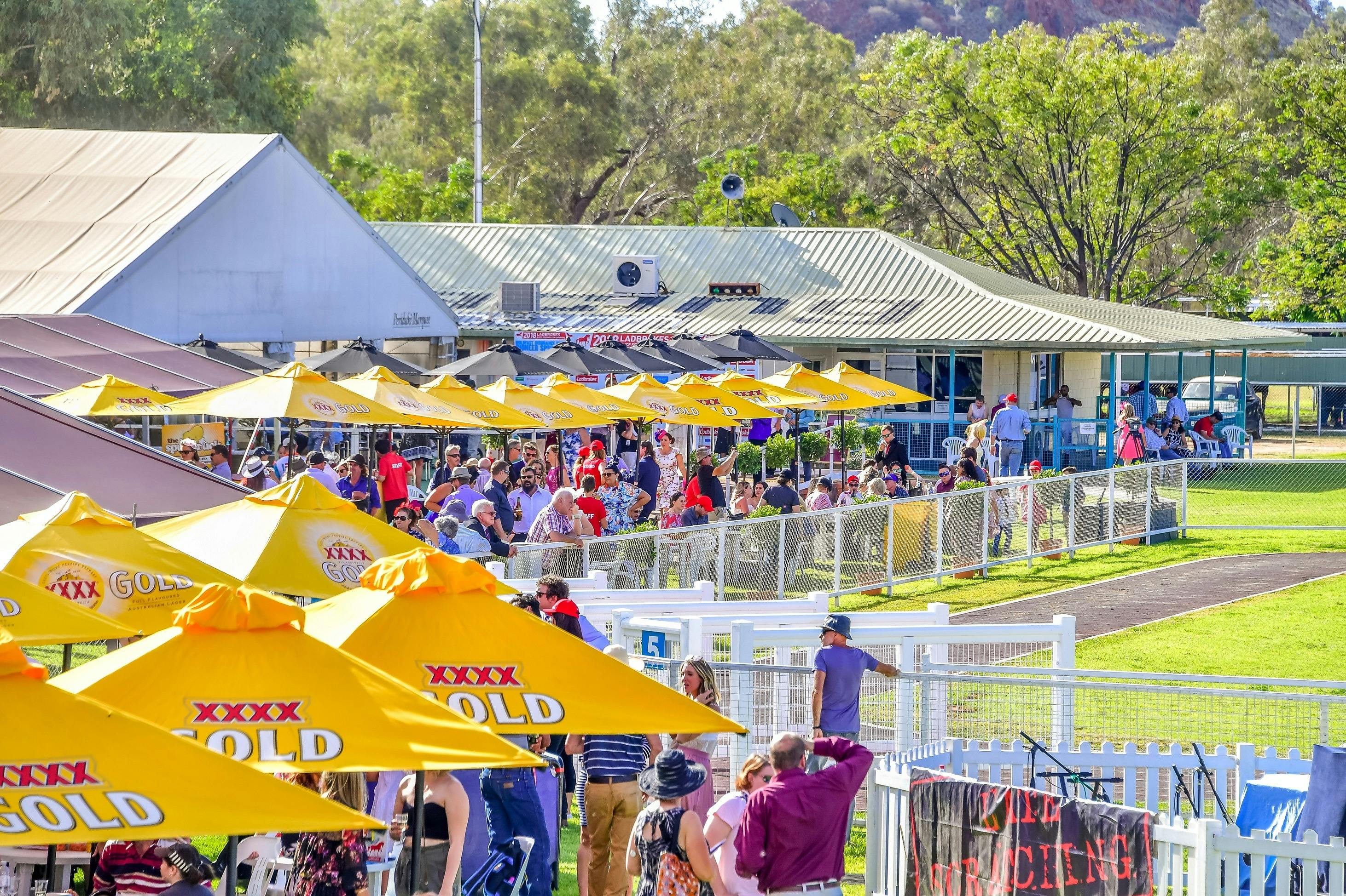 Lawns, umbrellas and the crowd waiting for the next race