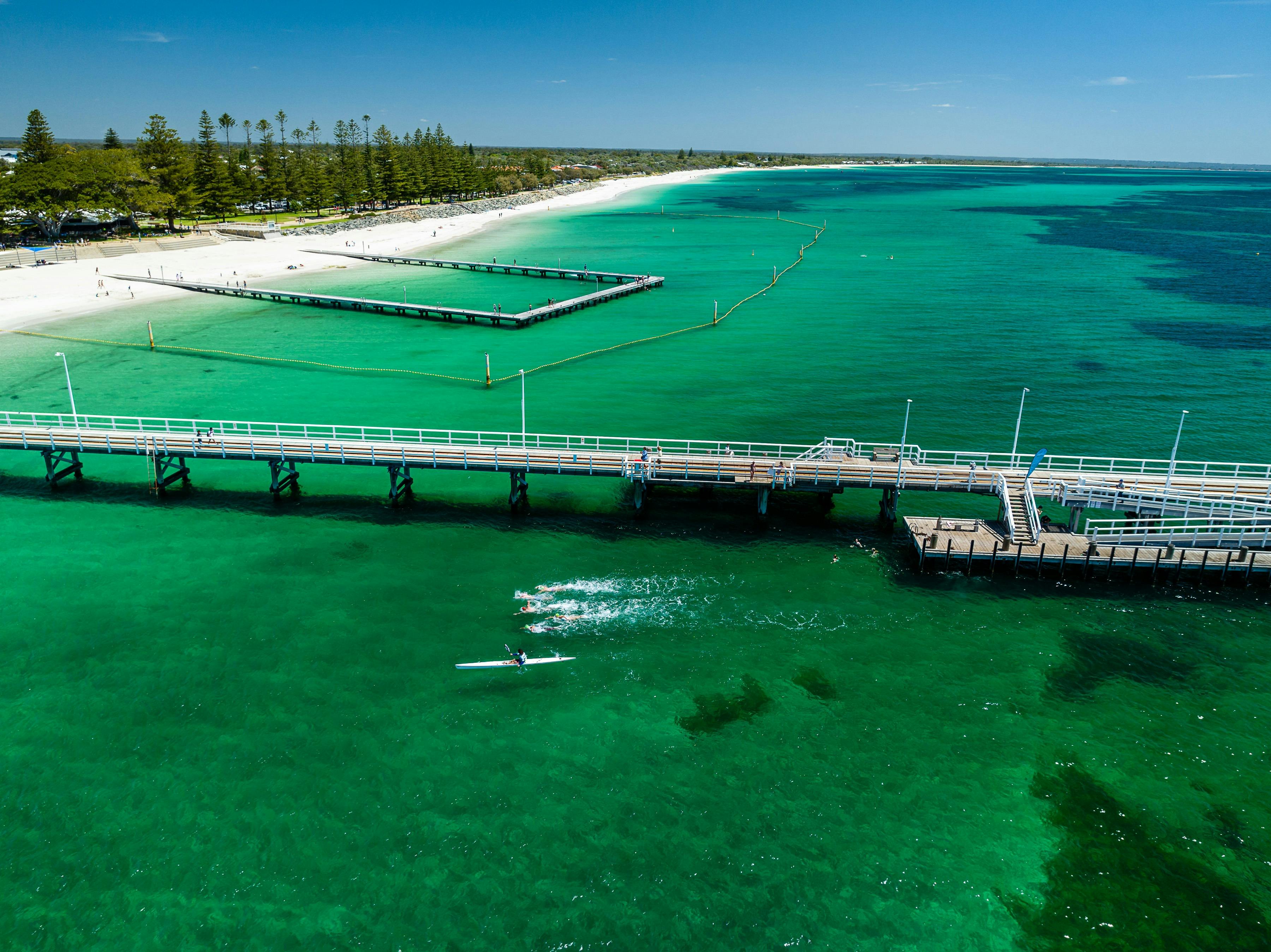 Swimmers will make the final turn under the iconic Busselton jetty