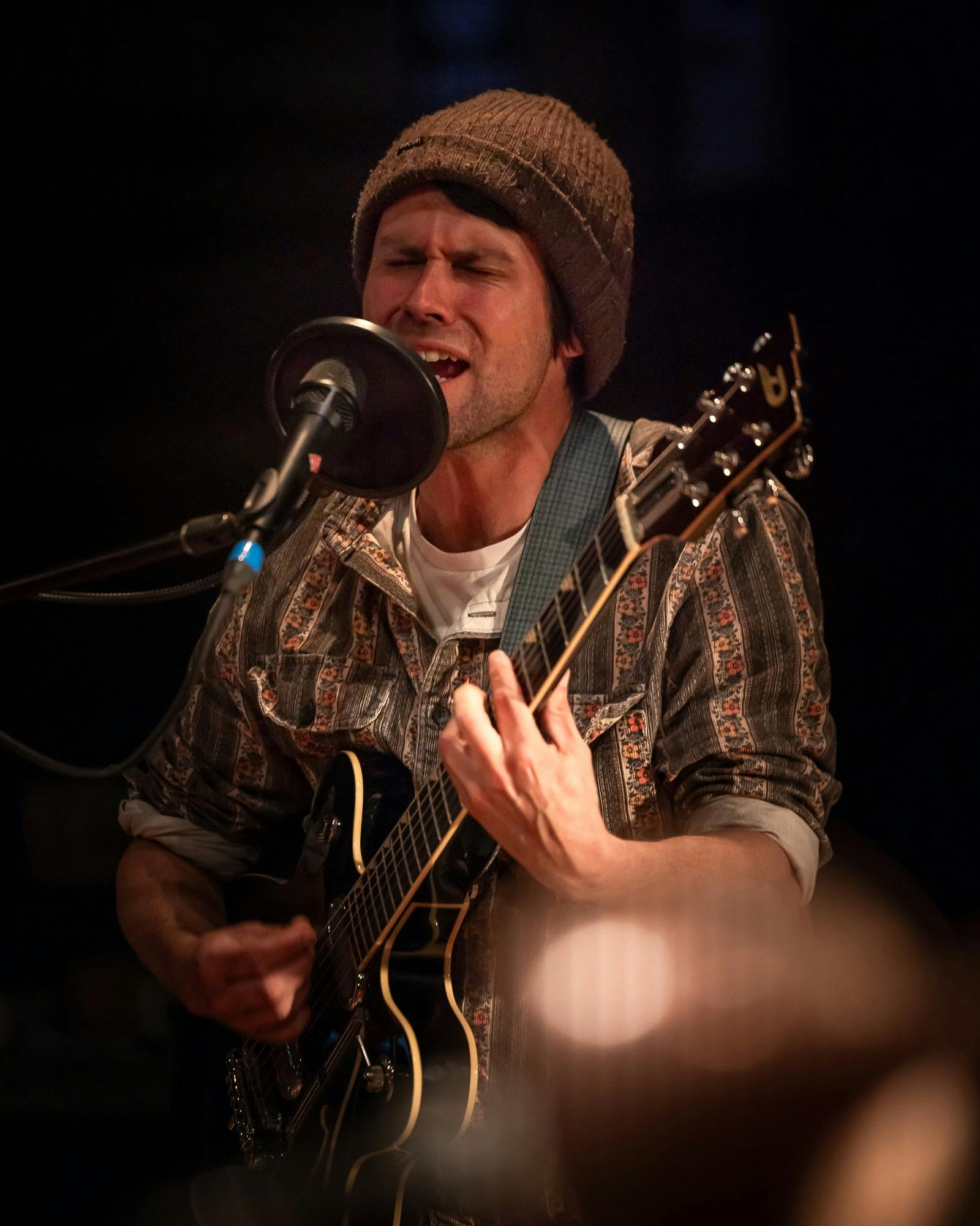 man playing guitar and singing