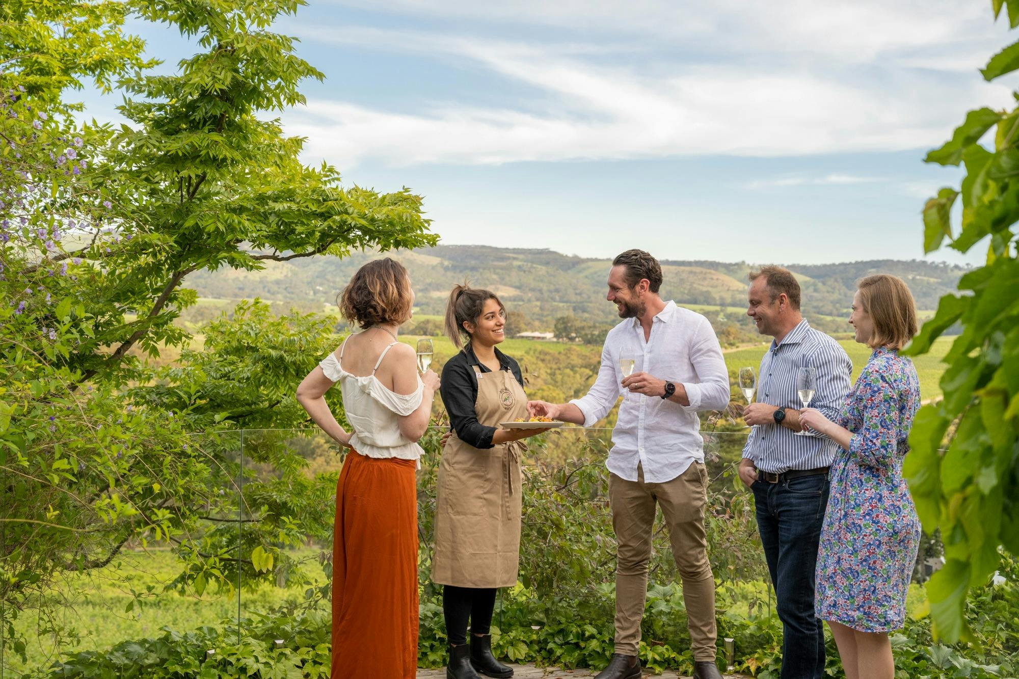 Canapes being served in a picturesque garden setting with beautiful view.