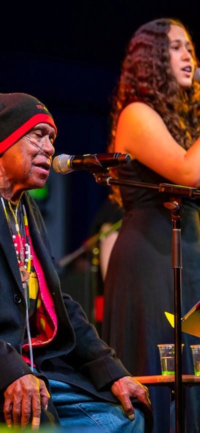 Uncle Archie Roach and young singer-songwriter Layla Barnett perform on stage