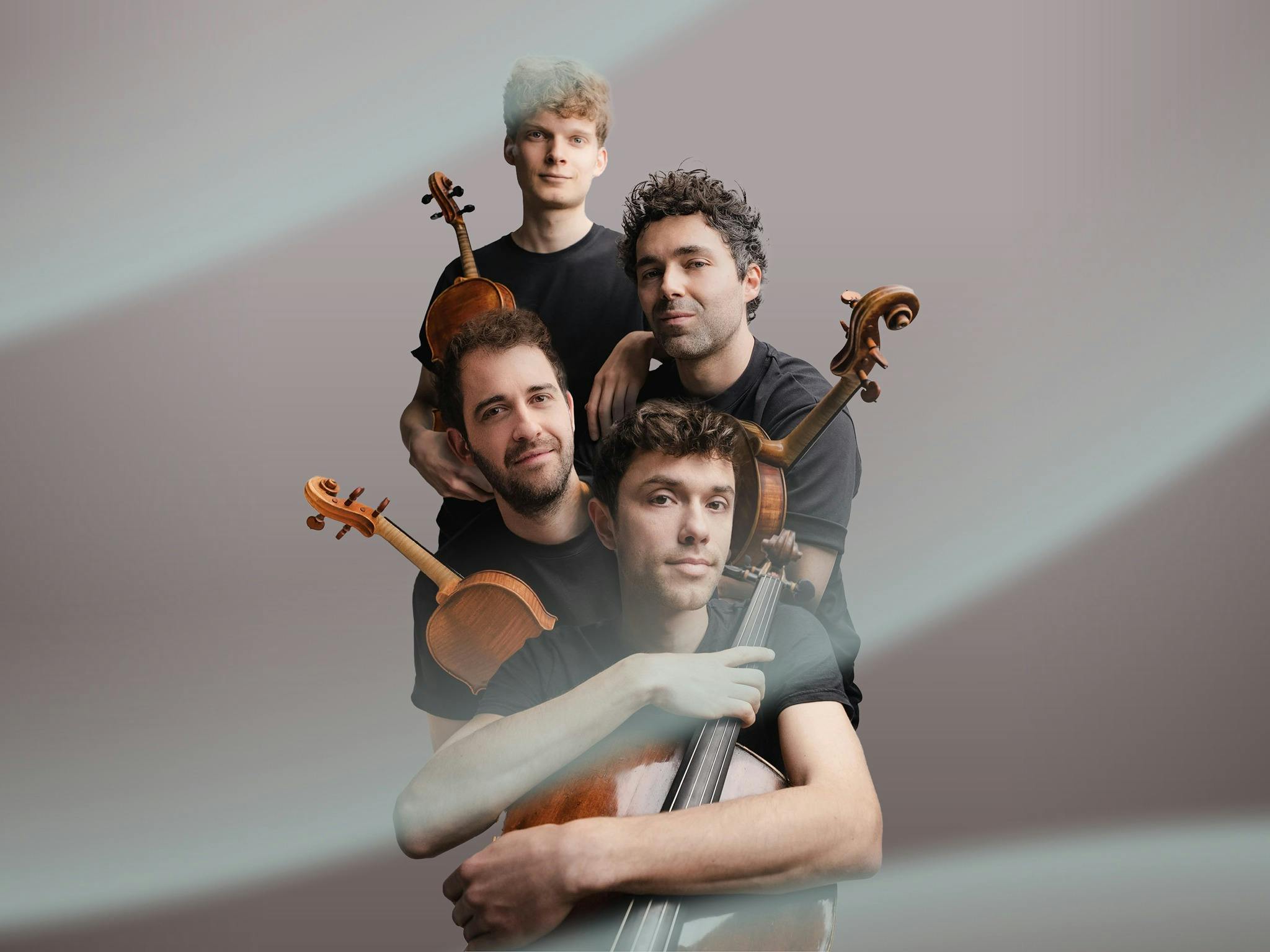 The four members of the Vision String Quartet holding their instruments