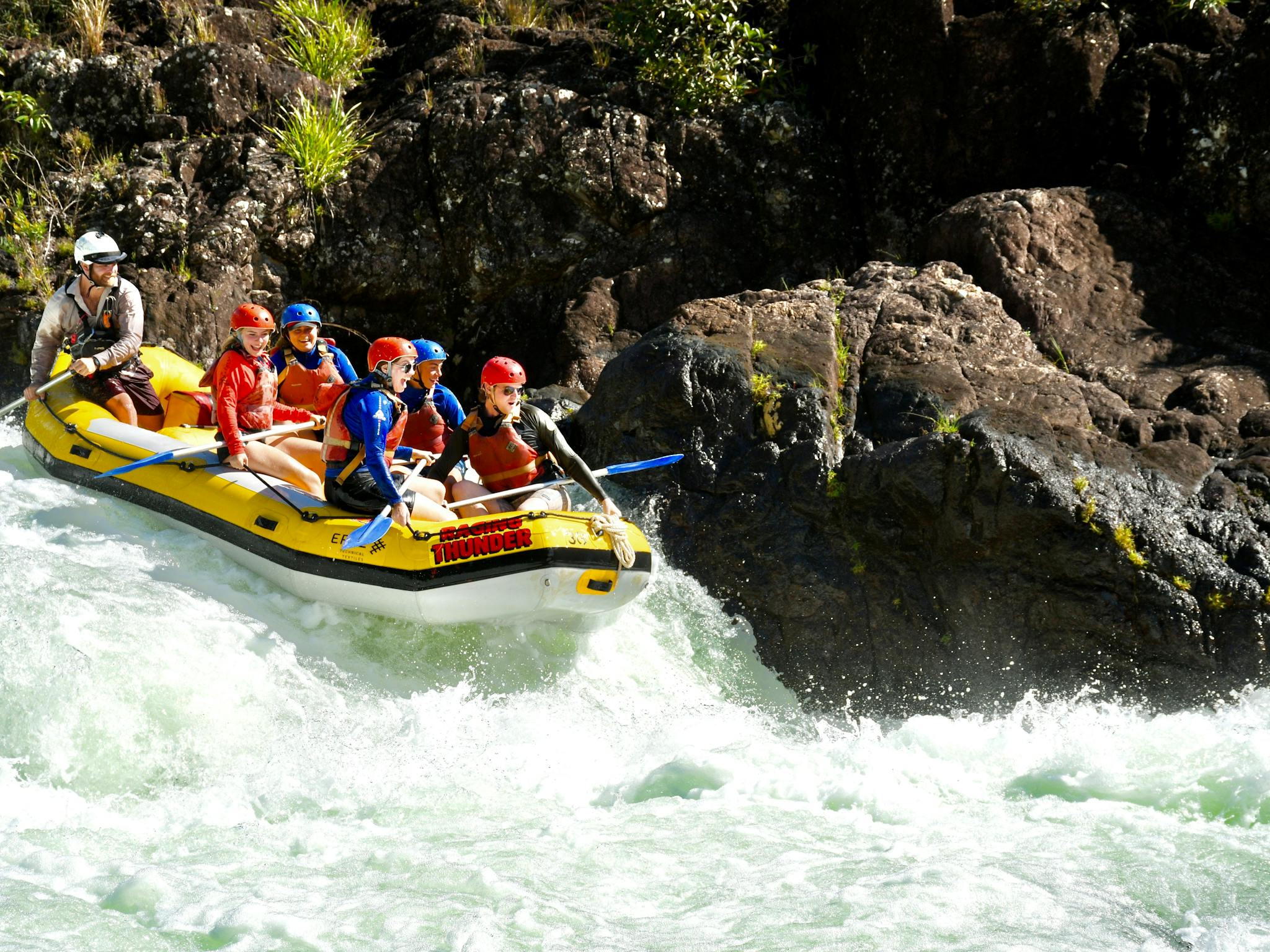 Group of Rafters approaching a rapid on the Tully Gorge National Park River on Cassowary Coast Group of Rafters approaching a rapid on the Tully Gorge National Park River on Cassowary Coast