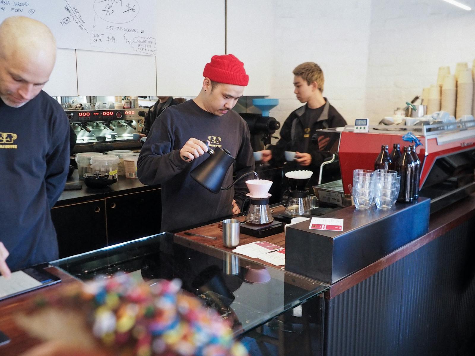 Staff brewing pour over coffee in Sample Coffee Surry Hills.