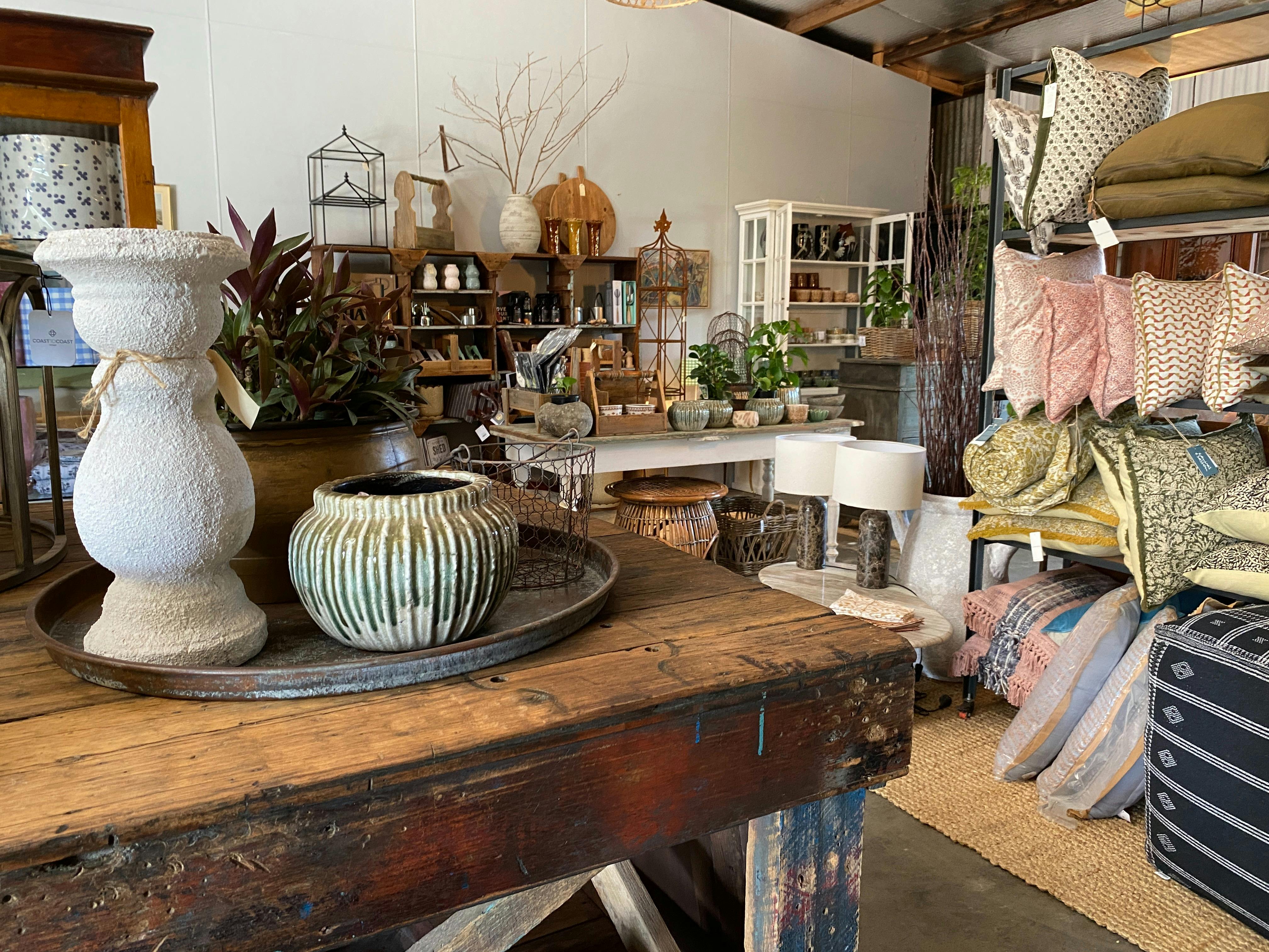 An eclectic mix of homewares sit nestled amongst one-off pieces of restored rustic vintage furniture