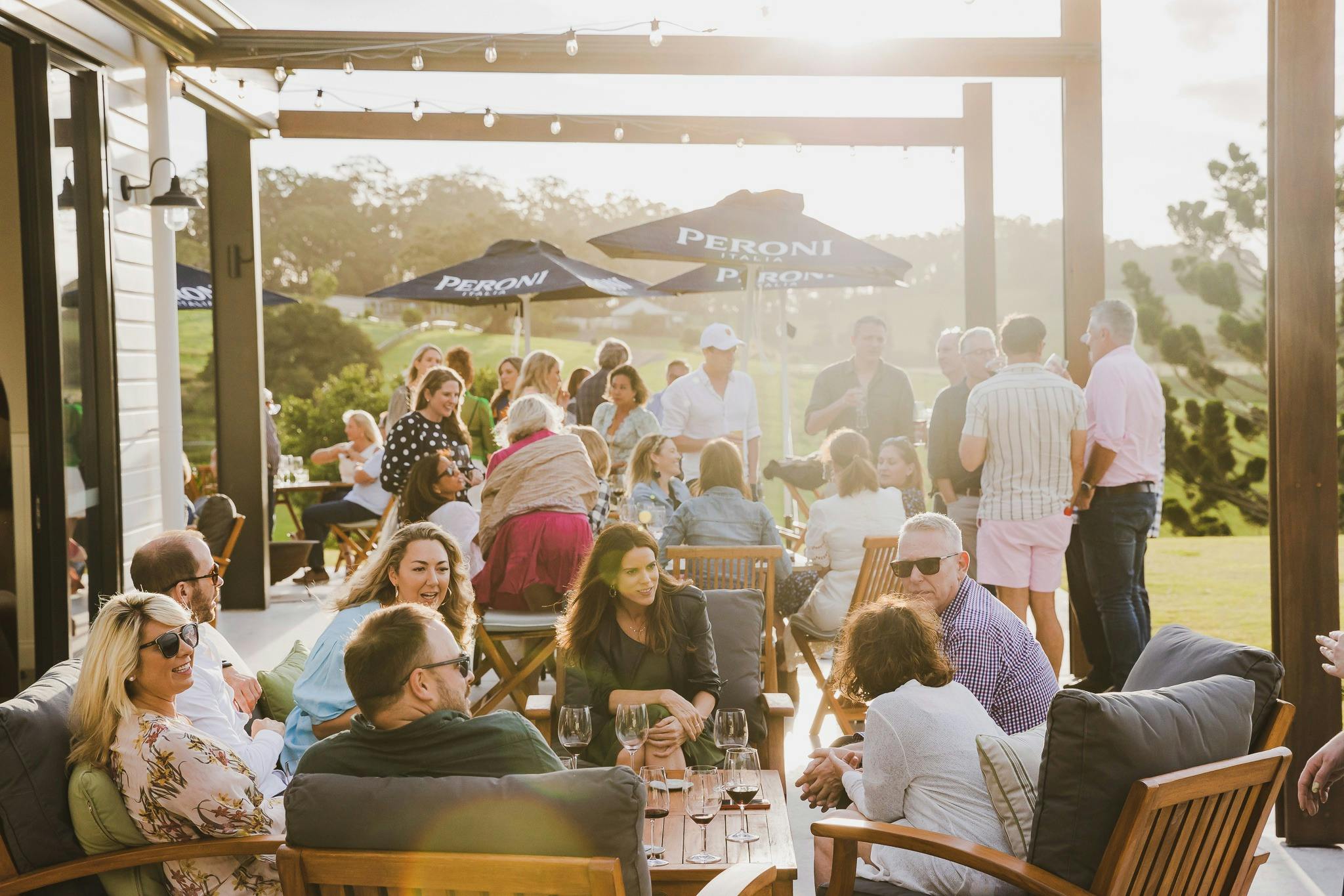 Guests enjoying a drink on The Paddock restaurant's Sunset Terrace