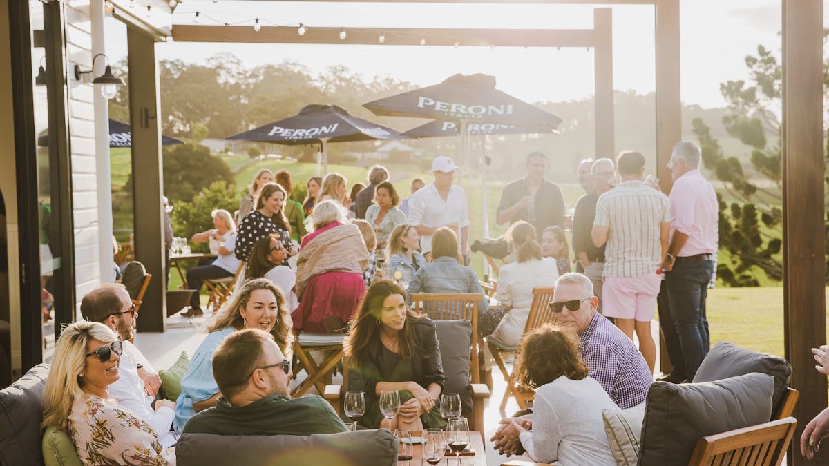 Guests enjoying a drink on The Paddock restaurant's Sunset Terrace