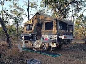 Camper trailer set up at campsite at Samson Creek Nature Park.