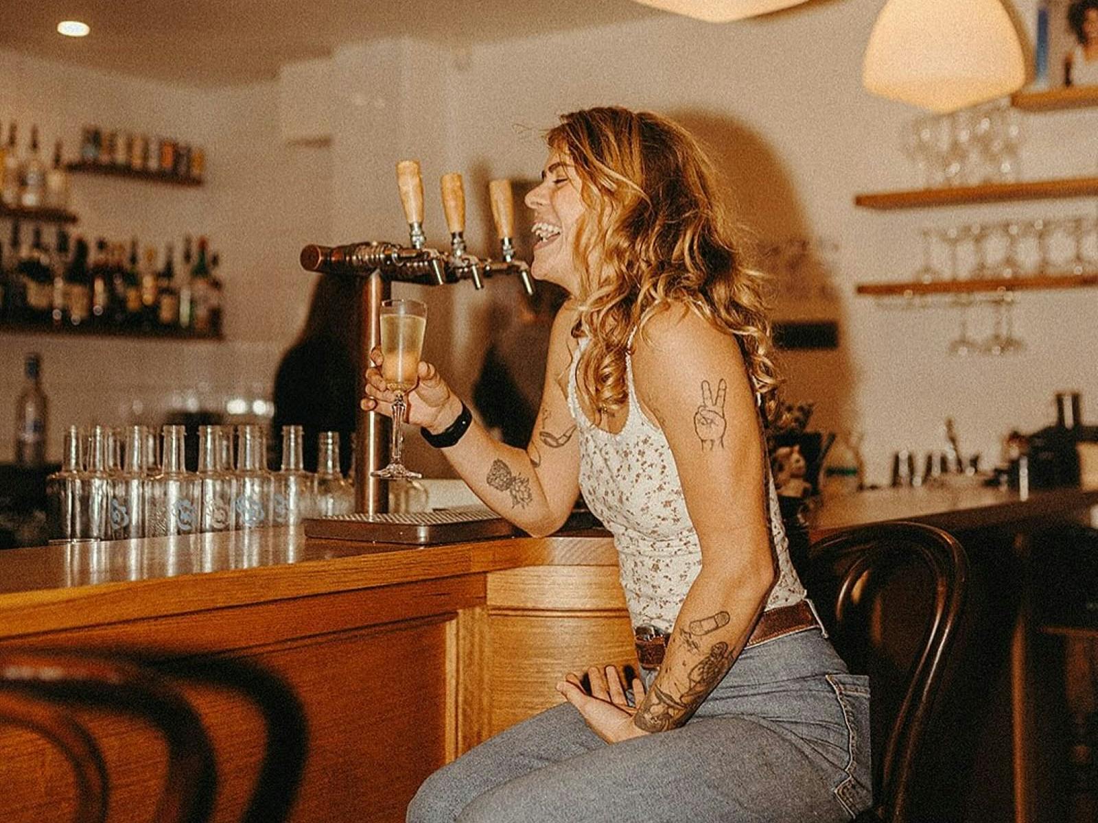Lady laughing at the bar