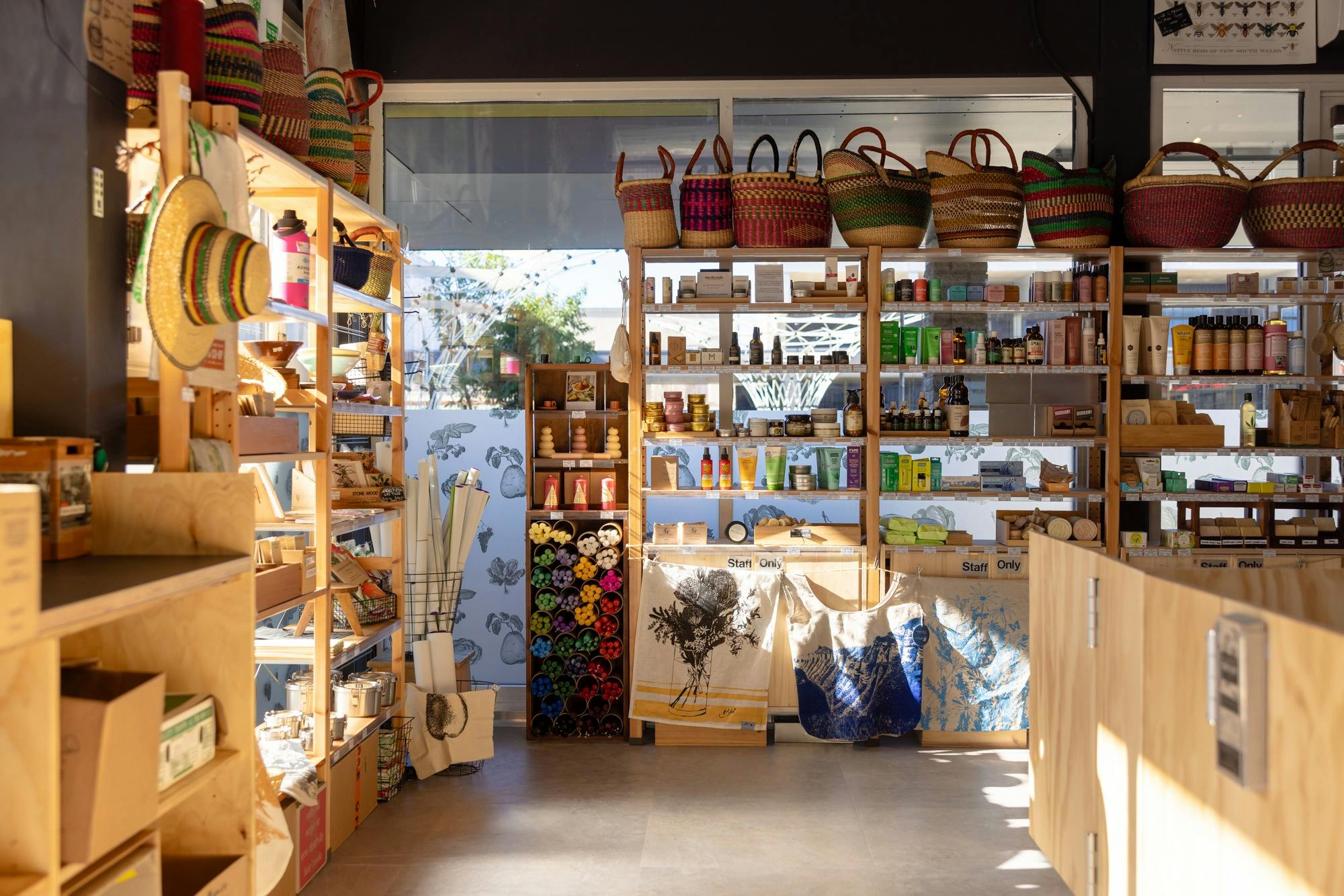 Shelfs in the sunlight fall of personal care products, baskets at the top.