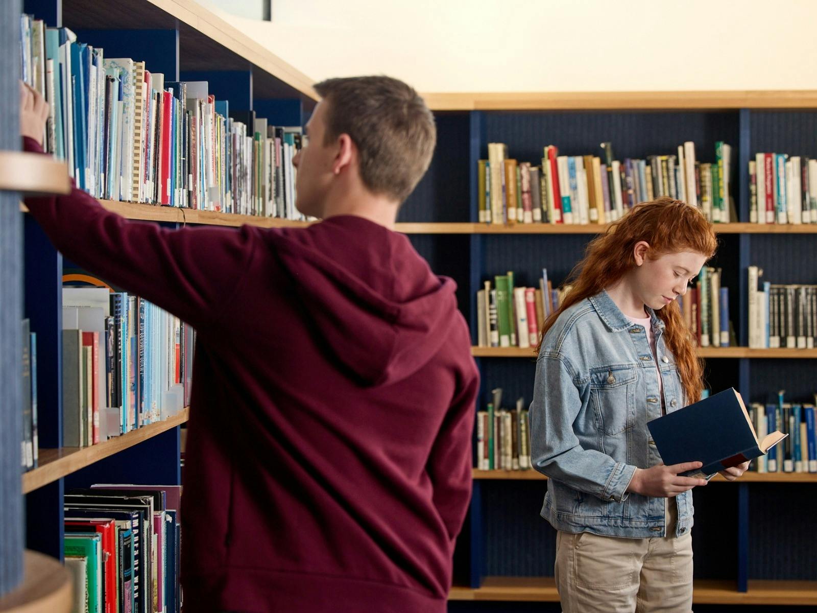 Visitors looking through books at the Charles Bean Research Centre