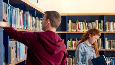 Visitors looking through books at the Charles Bean Research Centre